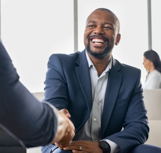 Family sitting on their front porch. They are smilling